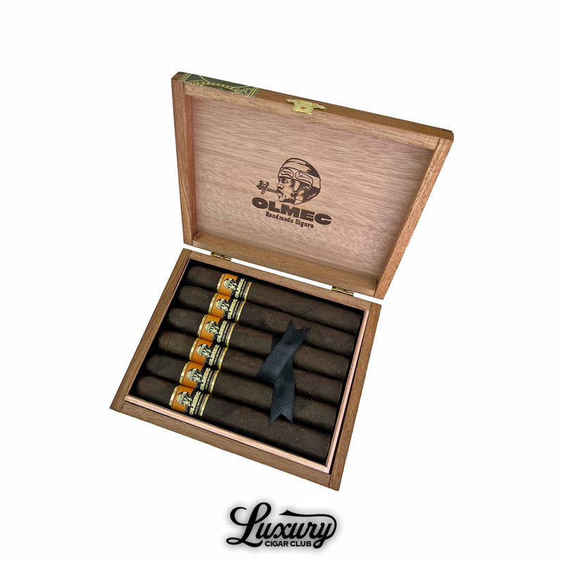 Open box of Foundation Olmec Maduro Toro cigars featuring six dark handmade cigars with gold and black bands, elegantly packed with a black ribbon, displayed by Luxury Cigar Club.