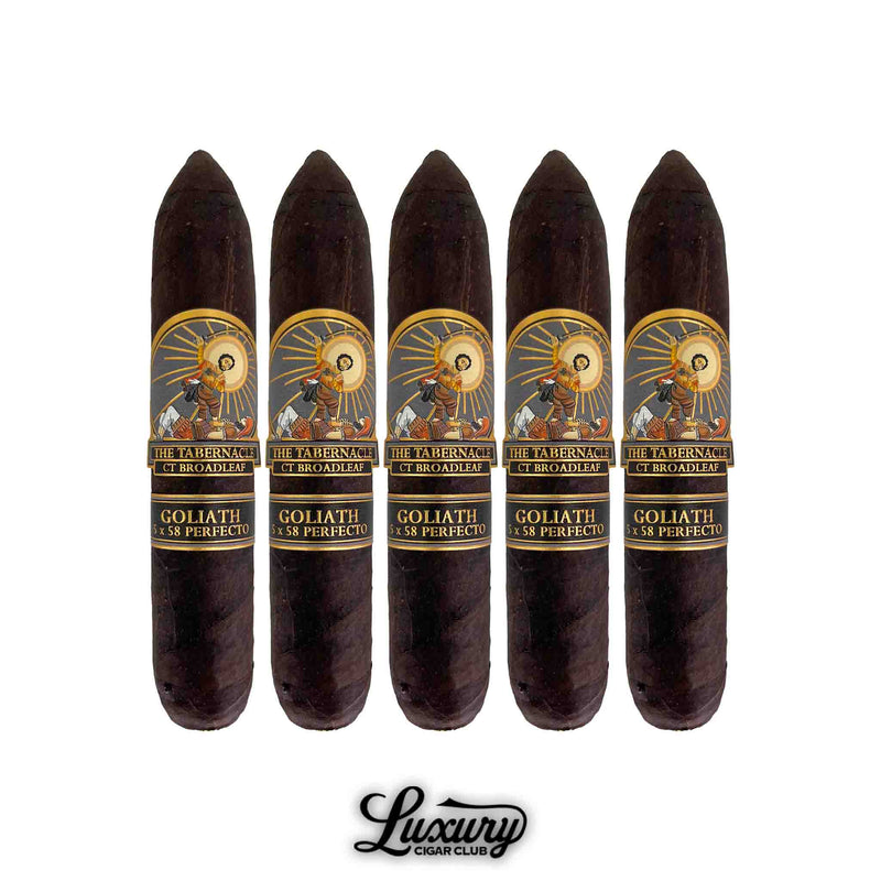 Five Foundation The Tabernacle Broadleaf Goliath Limited Edition cigars lined up, featuring dark Connecticut Broadleaf wrappers and detailed gold, black, and red bands depicting biblical artwork. Luxury Cigar Club logo below.