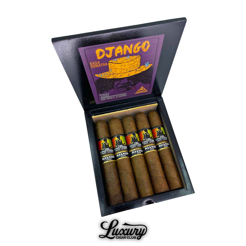 Open box of Foundation The Upsetters Django cigars, showing 7 medium-brown cigars with vibrant black, yellow, and orange bands depicting a silhouetted figure. The box lid features bold artwork with a golden hat on a purple background labeled “DJANGO 5x54 SUMATRA” and “THE UPSETTERS,” with “Luxury Cigar Club” branding below.