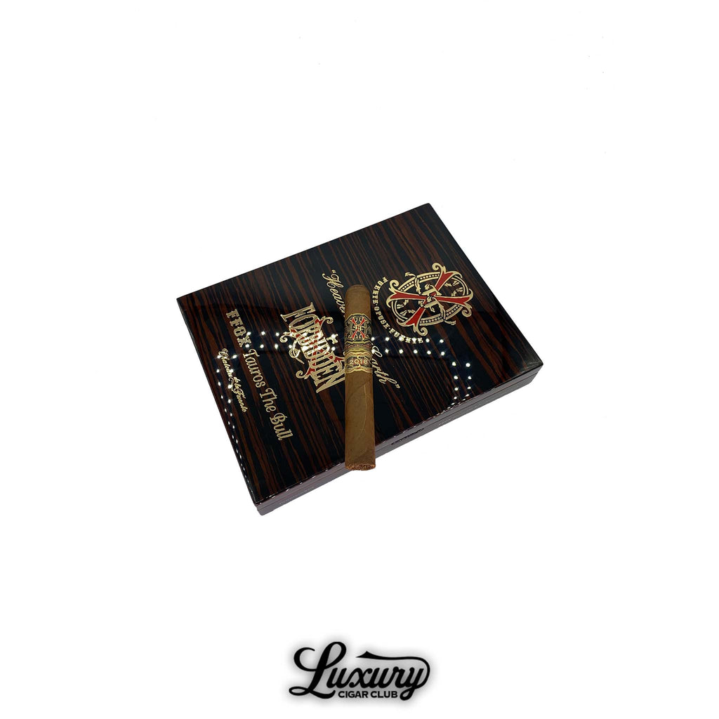 Fuente Fuente Opus X Heaven and Earth Tauros the Bull Natural Toro cigar resting on a glossy, striped collector’s box with gold and red logo detailing.