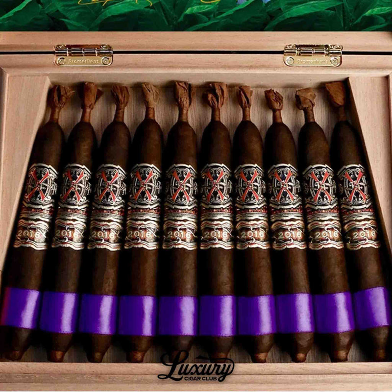 Open Prometheus humidor box of Fuente Fuente Opus X Heaven and Earth BBMF Maduro Unicorn cigars with ornate silver and red bands, purple foot ribbons, available at Luxury Cigar Club.