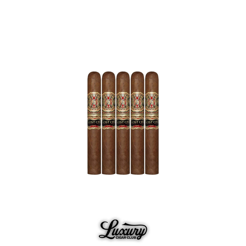 Fuente Fuente Opus X The Lost City Double Robusto cigars with red and gold bands lined up in front of Luxury Cigar Club logo
