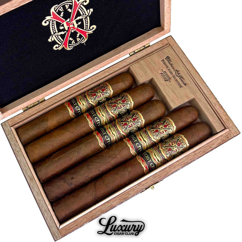 Close Up of Arturo Fuente Fuente OpusX The Lost City Sampler box showing five premium cigars with signature red and gold OpusX bands, presented by Luxury Cigar Club.