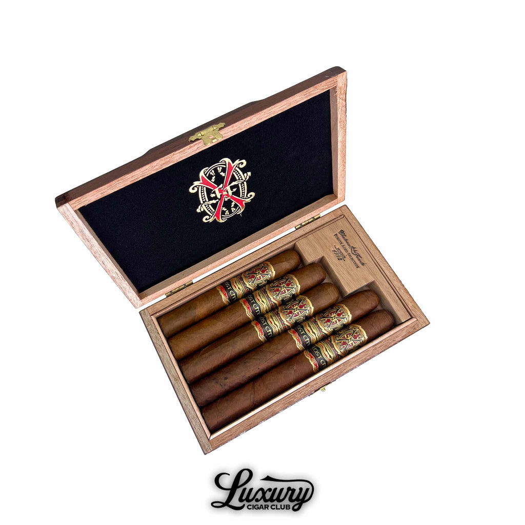 Arturo Fuente Fuente OpusX The Lost City Sampler 5-Cigar Assortment displayed in a luxurious black and cedar box with the OpusX logo, available through Luxury Cigar Club.