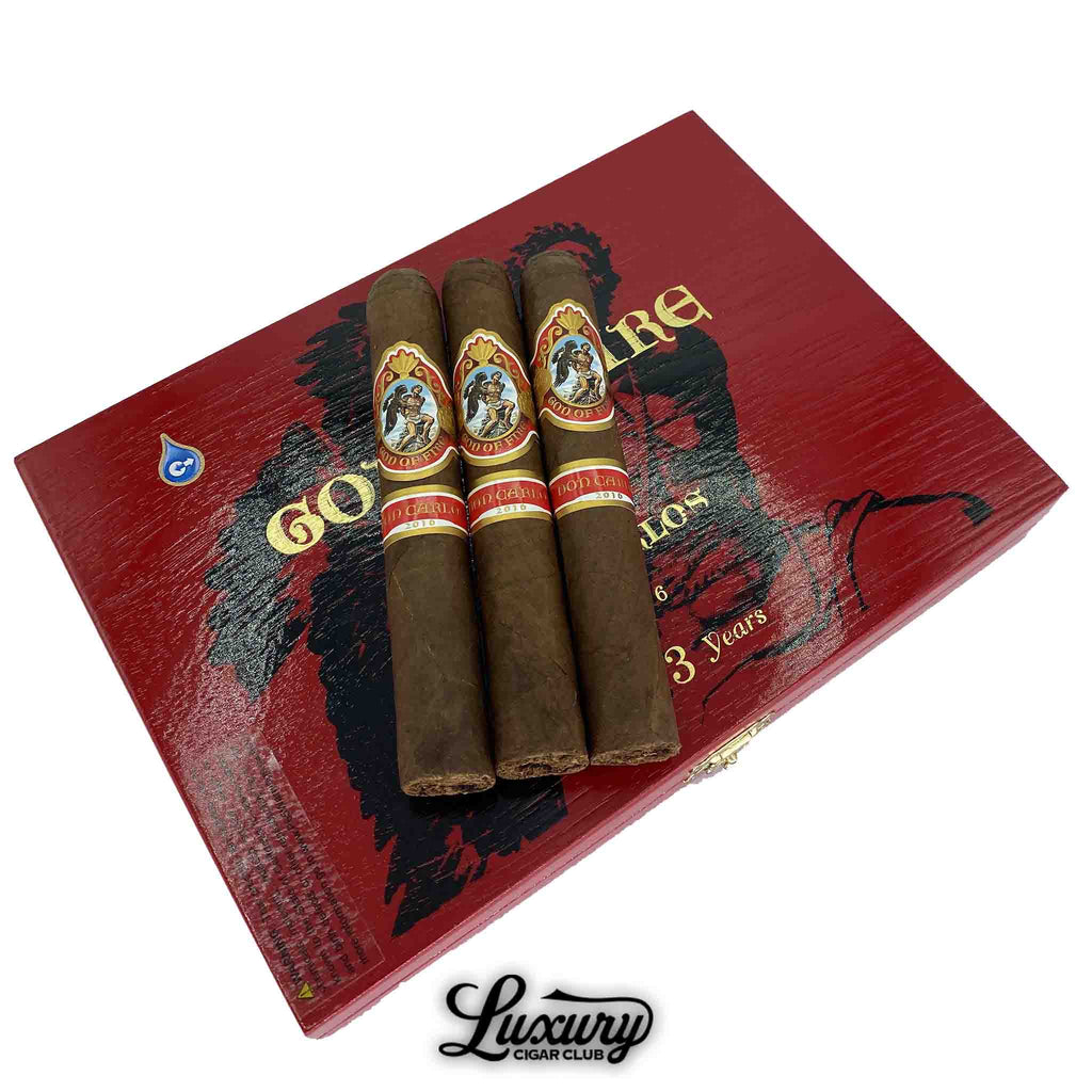 God of Fire by Don Carlos cigars resting on a bold red and black cigar box with Luxury Cigar Club branding