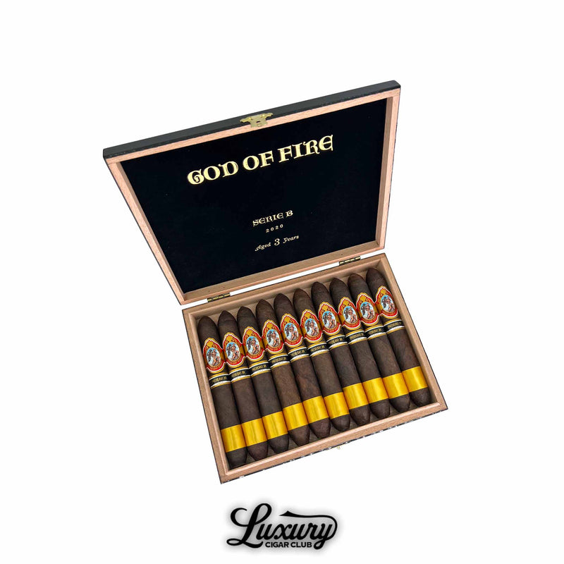 God of Fire Serie B Diademas 56 cigars in an open black box with gold lettering showing tapered dark wrapped cigars with gold foot bands arranged in two rows for Luxury Cigar Club