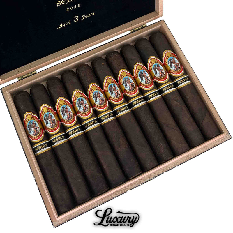 Close-up of God of Fire Serie B Gran Toro 2020 cigars aged 3 years – ultra-premium dark-wrapped cigars by Arturo Fuente with intricate red and gold bands, offered by Luxury Cigar Club