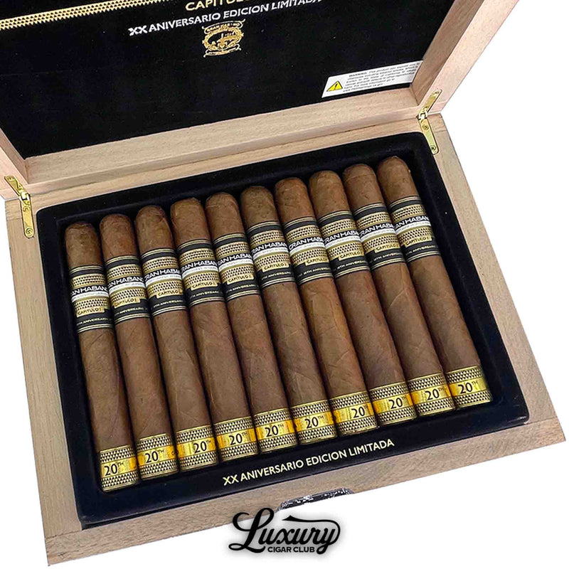 Close up of Gran Habano 20th Aniversario Capitulo I El Desafío cigars inside box, black and gold band details visible, Luxury Cigar Club