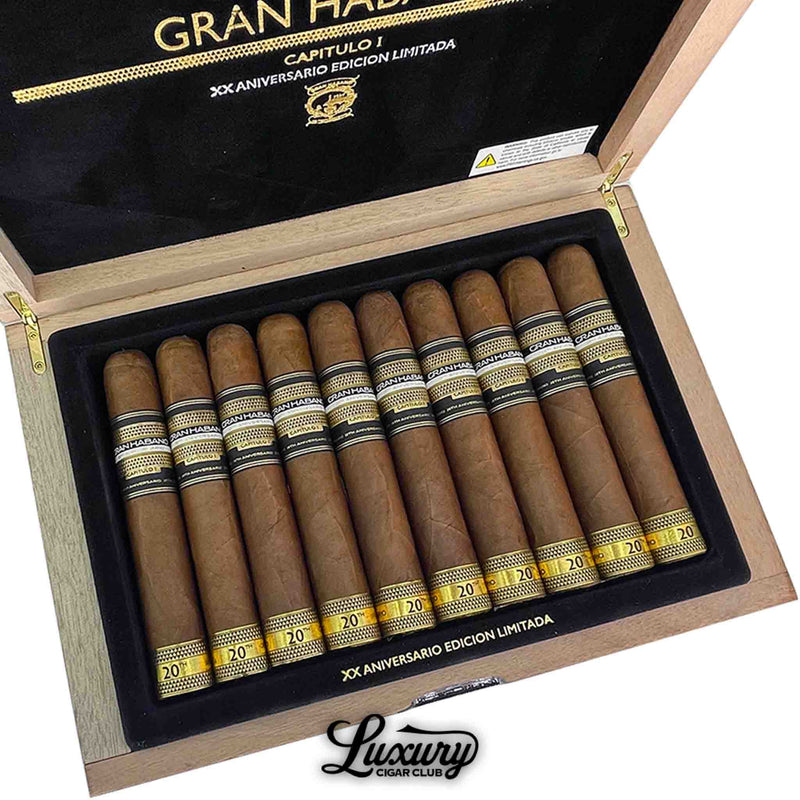 Close up of Gran Habano 20th Aniversario Capitulo I El Triunfo cigars lined inside open box with black and gold branding, Luxury Cigar Club