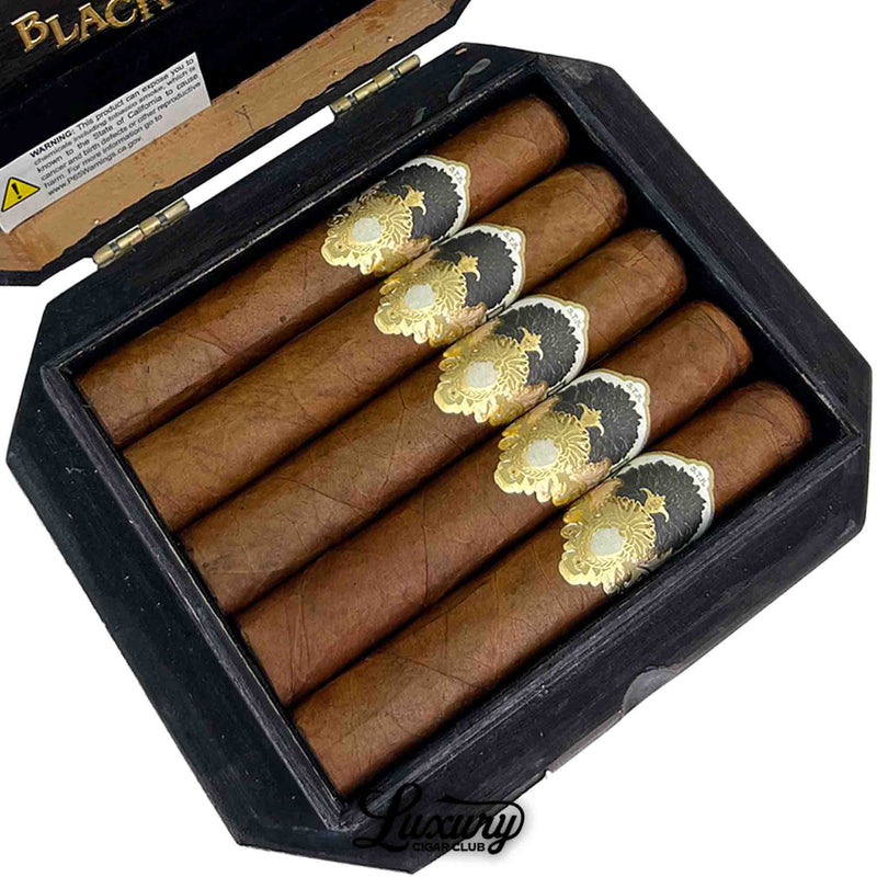 Close-up of Gran Habano Black Dahlia Robusto cigars with ornate gold and black cigar bands from Luxury Cigar Club.
