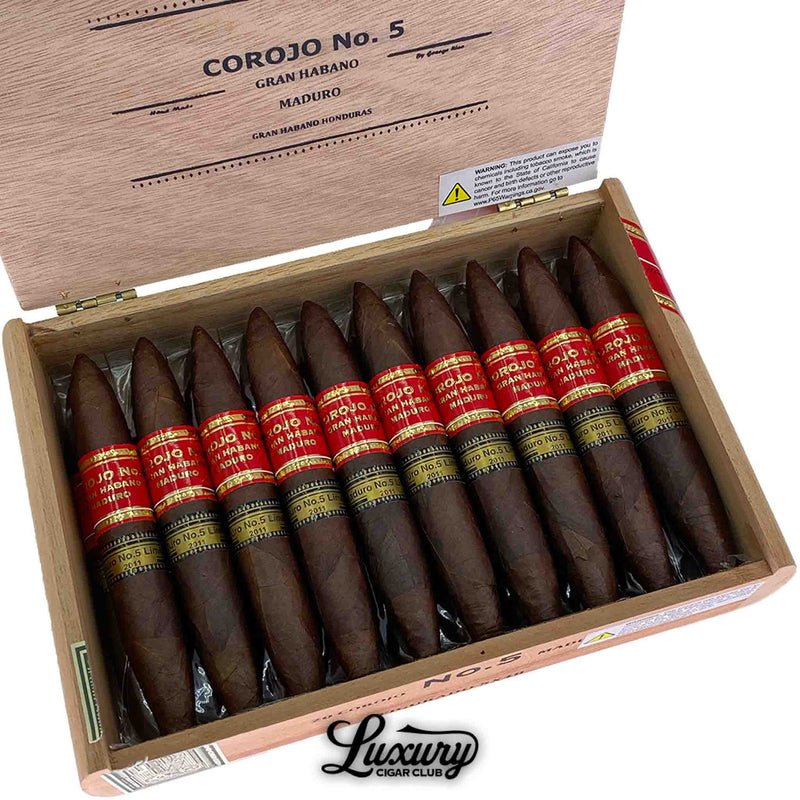 Close up of Gran Habano Corojo No. 5 Maduro Figurado cigars inside box, figurado tapered heads visible, red and black Corojo No. 5 bands, full box detail for Luxury Cigar Club.