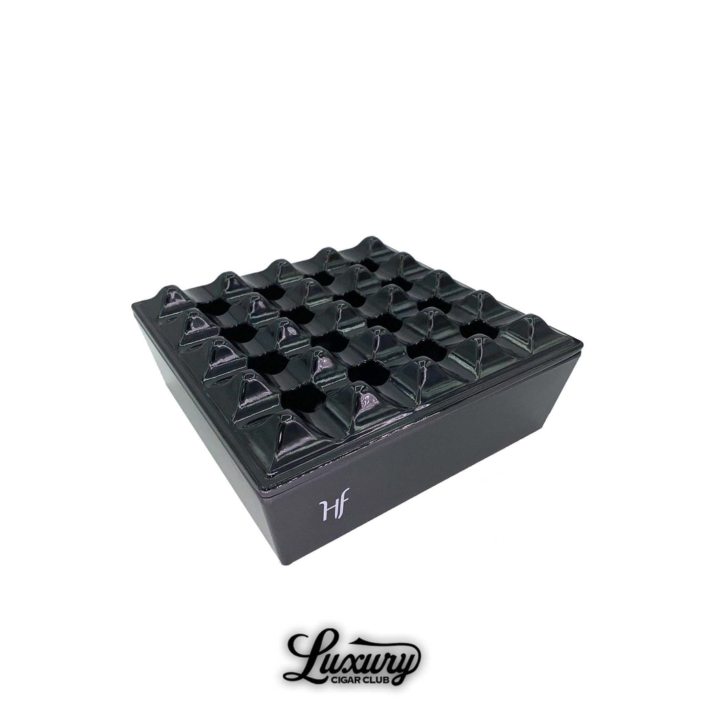 HF Barcelona Melamine Grid Ashtray in glossy black finish with geometric grid design, photographed on white background with Luxury Cigar Club logo.