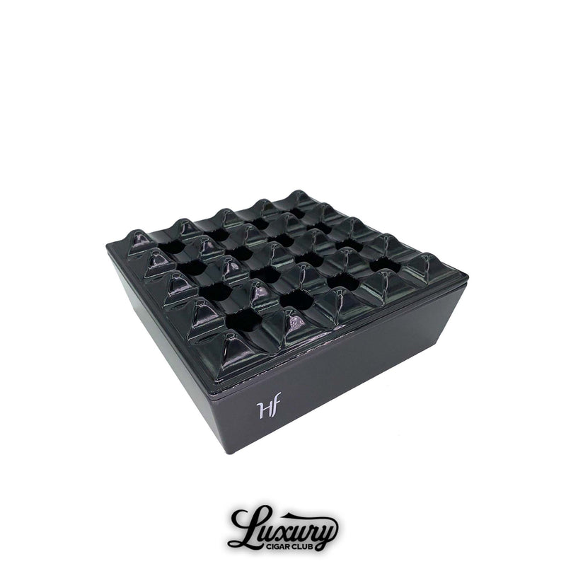 HF Barcelona Melamine Grid Ashtray in glossy black finish with geometric grid design, photographed on white background with Luxury Cigar Club logo.