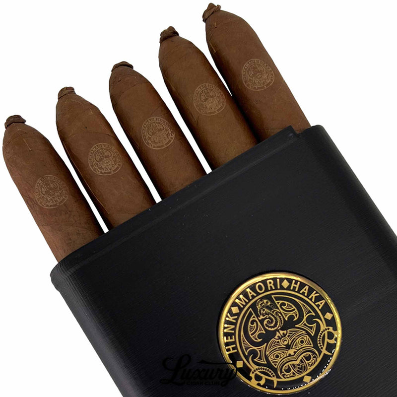 Close-up of Henk Maori Gaudi cigars showing fine construction and embossed logo, displayed by Luxury Cigar Club.