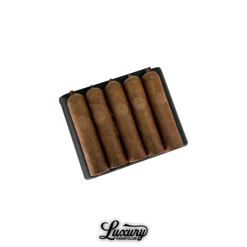 Henk Maori Gaudini cigars neatly arranged in an elegant black box with orange interior, offered by Luxury Cigar Club.