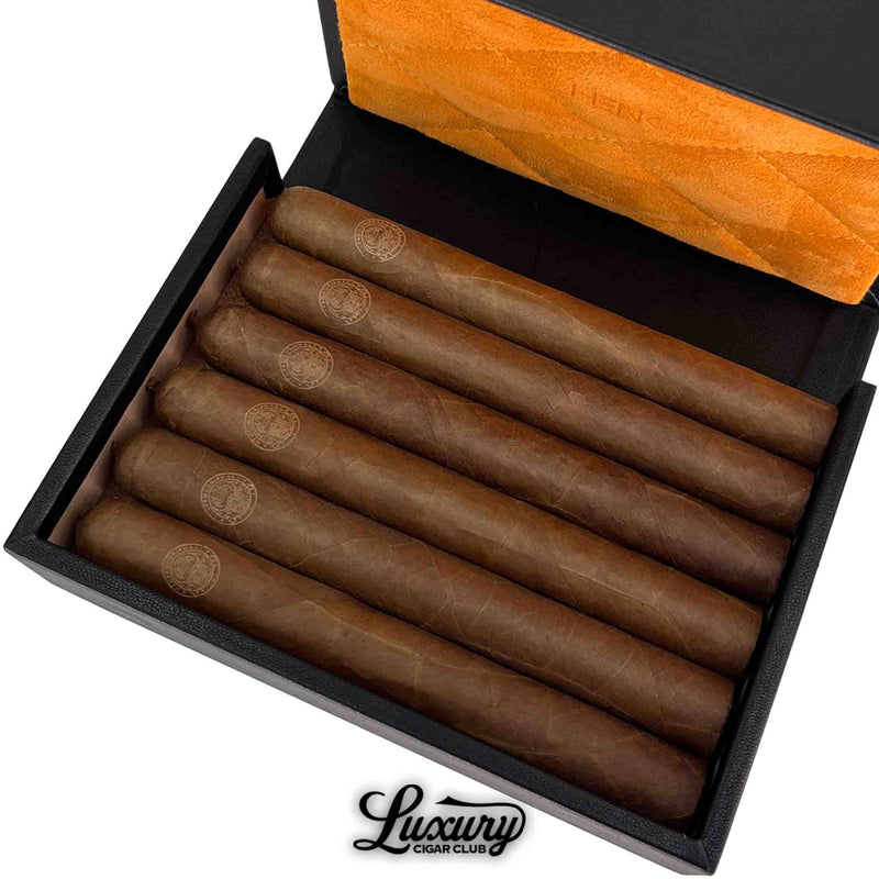 Close-up of Henk Maori La Doña cigars showing detailed logo etching and perfecto shape, presented by Luxury Cigar Club.