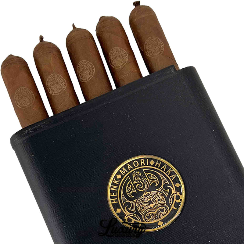 Close-up of Henk Maori Willy cigars revealing wrapper quality and gold logo detail, displayed by Luxury Cigar Club.