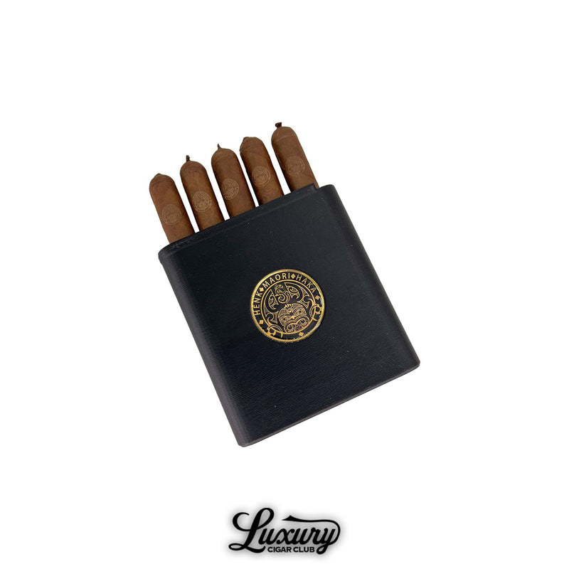 Henk Maori Willy cigars arranged in a sleek black case with gold Maori insignia, featured by Luxury Cigar Club.