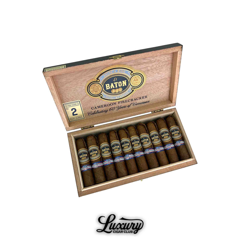 Open box of El Baton Cameroon Firecracker Petit Robusto cigars showing ten neatly arranged short cigars with rich brown wrappers inside a natural wood box featuring gold and navy branding, photographed by Luxury Cigar Club