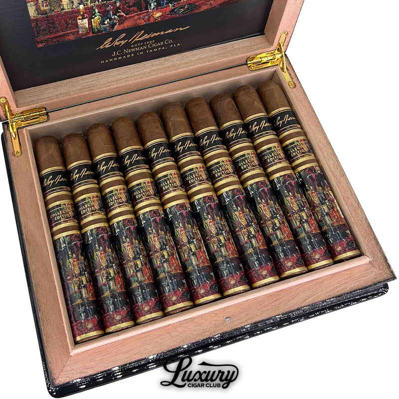 Close-up of JC Newman LeRoy Neiman Collector’s Edition 2023 Toro cigars inside the box, highlighting the detailed artistic cigar bands and luxurious craftsmanship, featured by Luxury Cigar Club.
