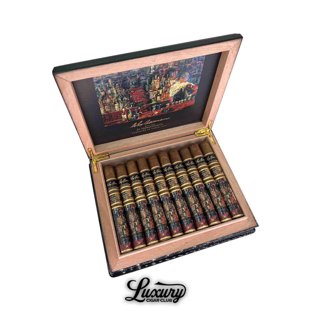JC Newman LeRoy Neiman Collector’s Edition 2023 Toro cigars displayed in an open humidor box featuring vibrant artwork and gold accents, presented by Luxury Cigar Club.