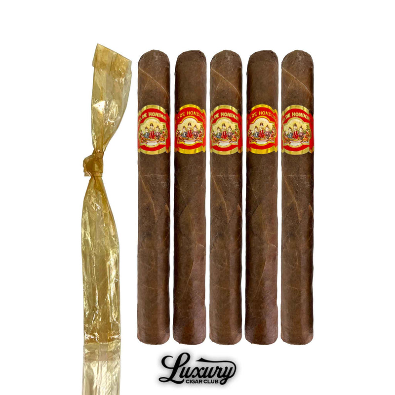 Five Joya de Honduras Churchill cigars from Luxury Cigar Club arranged in a row, each handcrafted in Honduras with smooth brown leaf and bold red-and-gold branding.