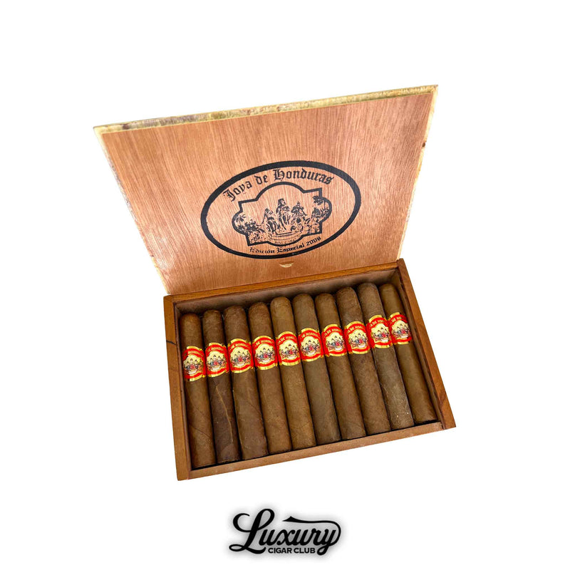 Open wooden box of Joya de Honduras Robusto cigars from Luxury Cigar Club, displaying twelve hand-rolled cigars with rich brown wrappers and bold red and gold bands.