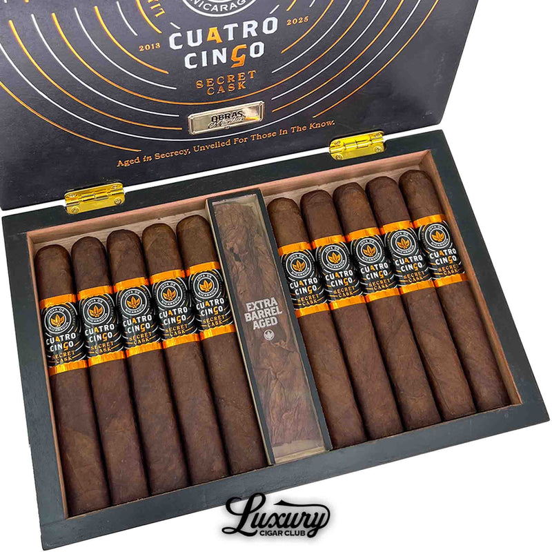 Close up view of Joya de Nicaragua Cuatro Cinco Secret Cask cigars from Luxury Cigar Club inside the box showing dark brown wrappers and orange black bands.