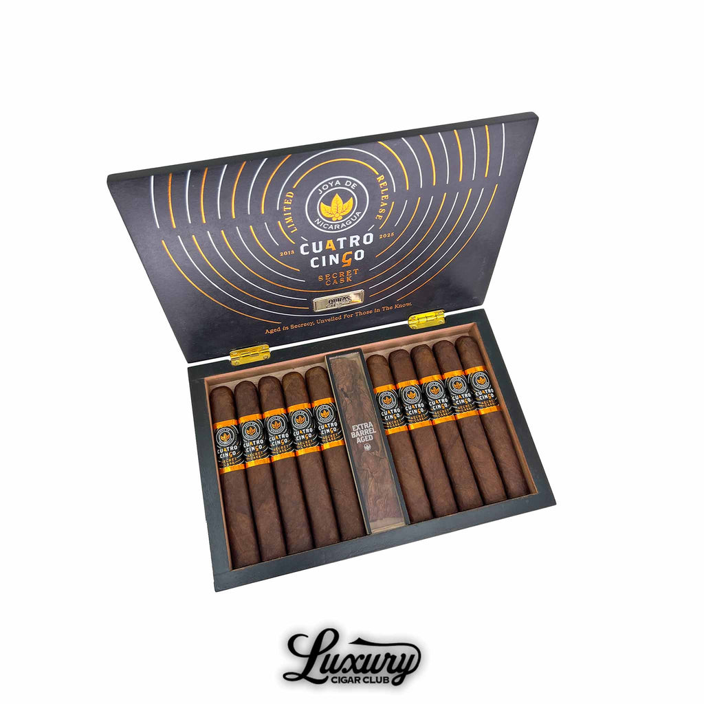 Open box of Joya de Nicaragua Cuatro Cinco Secret Cask cigars from Luxury Cigar Club in a black and gold box with orange and black cigar bands.