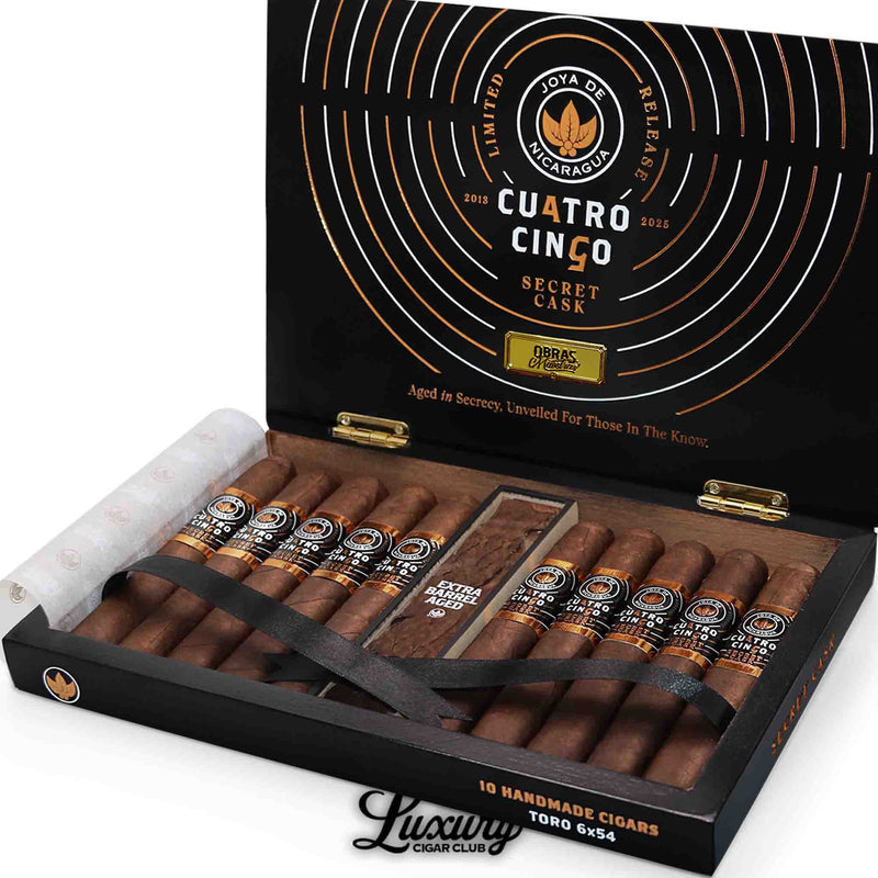 Close up of open black and gold Joya de Nicaragua Cuatro Cinco Secret Cask Toro BP cigar box showing cigars in neat rows at Luxury Cigar Club.