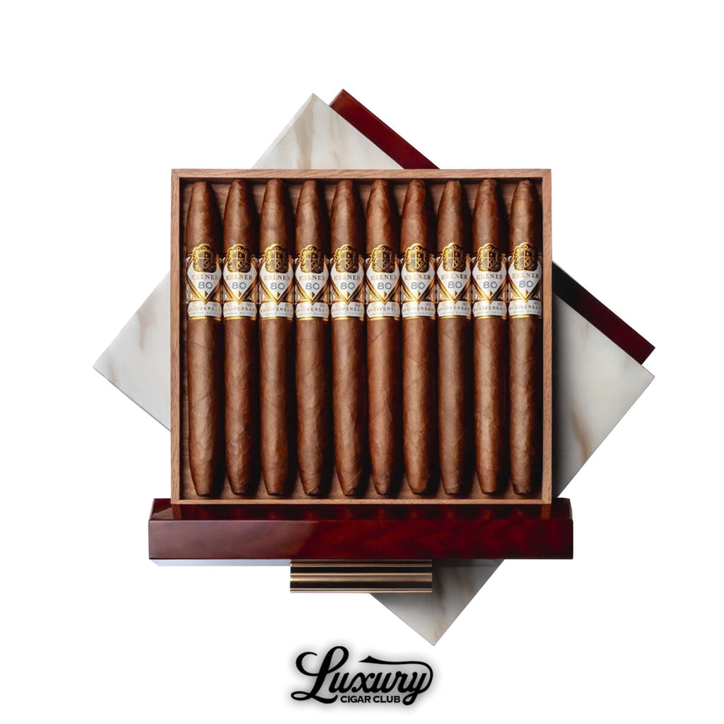 Open box of Kelner LE 80 cigars from Luxury Cigar Club, showcasing 10 limited edition perfecto-shaped cigars with gold and white bands inside a luxurious marble-accented wooden box.