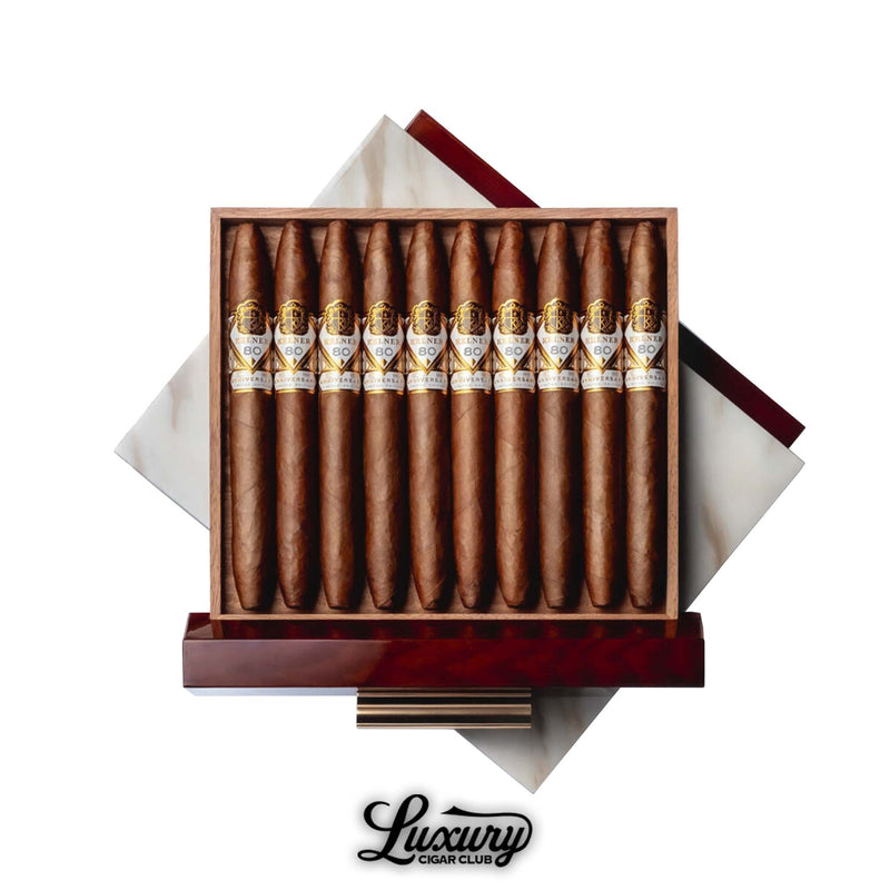 Open box of Kelner LE 80 cigars from Luxury Cigar Club, showcasing 10 limited edition perfecto-shaped cigars with gold and white bands inside a luxurious marble-accented wooden box.