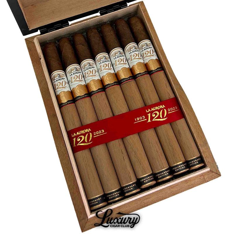 Close-up of La Aurora 120th Anniversary Edition Lancero box showing premium long cigars with white, gold, and red anniversary bands marked “1903–2023” Dominican handmade.