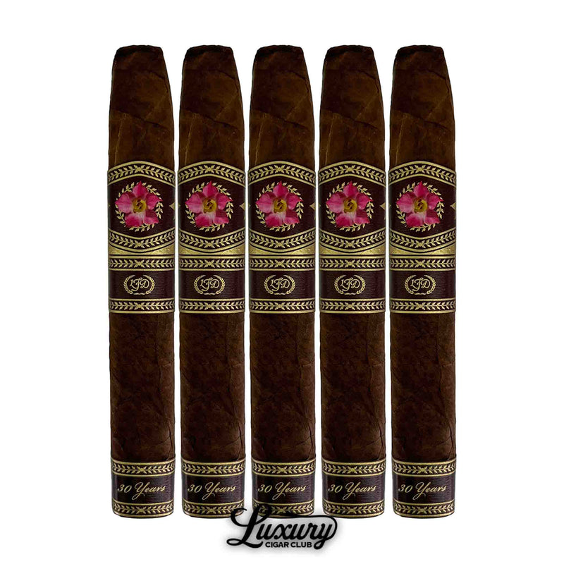 Five La Flor Dominicana 30th Anniversary Chisel cigars in a row with pink and gold bands, displayed with Luxury Cigar Club logo.