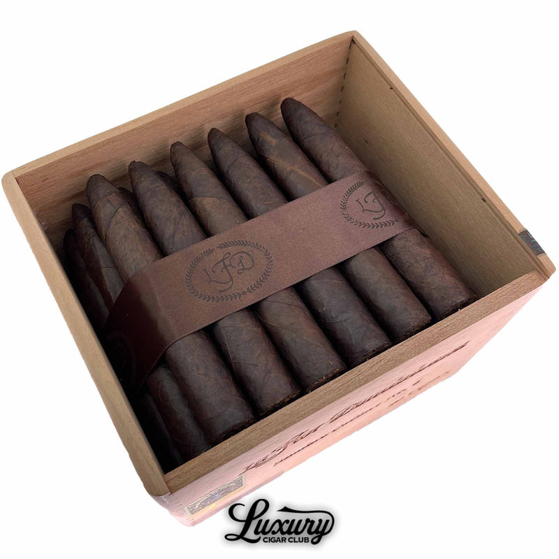 Close-up of La Flor Dominicana Cabinet No. 6 Maduro Limited Release cigars arranged neatly in a wooden box, showcasing rich dark Maduro wrappers and the embossed brown LFD band. Luxury Cigar Club logo beneath.