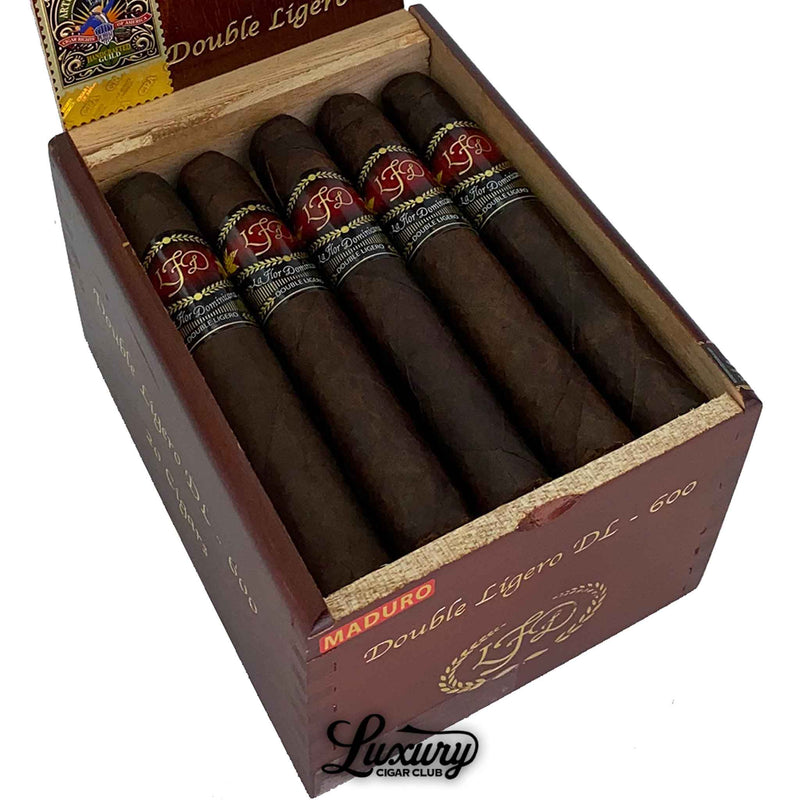 Close-up of La Flor Dominicana Double Ligero Maduro DL-600 cigars showing dark oily wrappers and red-black bands, featured by Luxury Cigar Club.