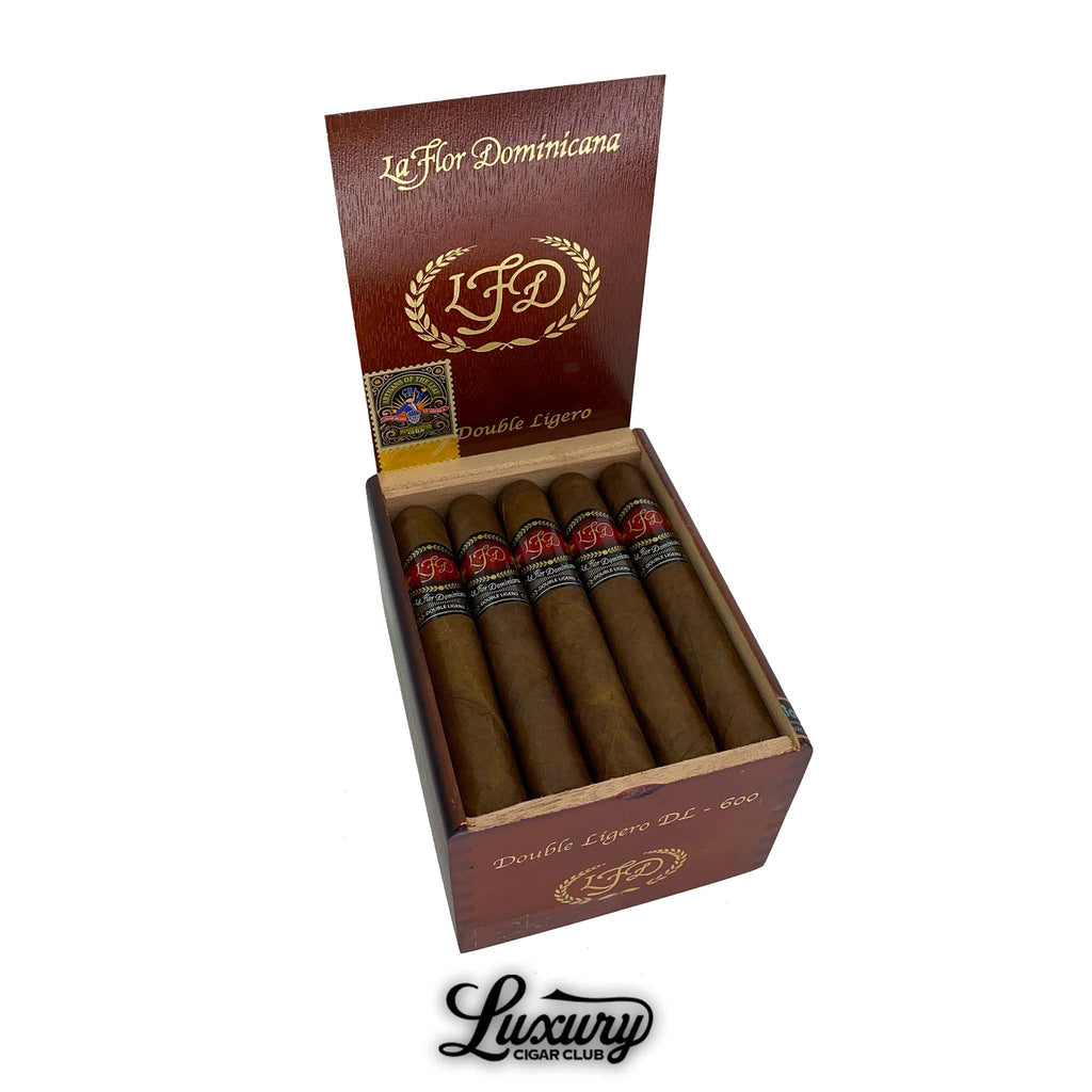 La Flor Dominicana Double Ligero Natural DL-600 cigars showcased in an open cedar box with the brand’s gold and red band design, available at Luxury Cigar Club.