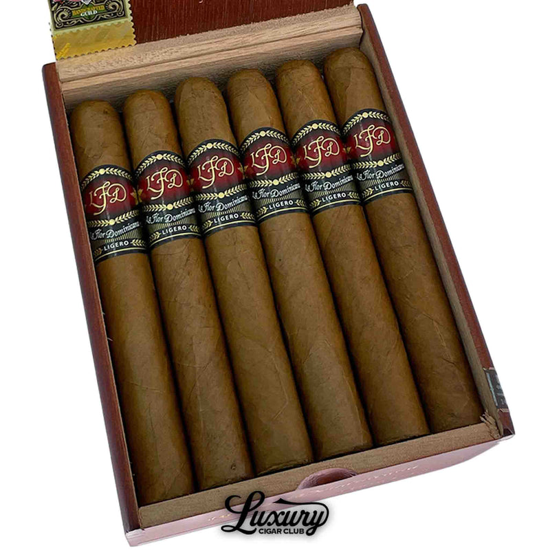 Close-up of La Flor Dominicana Ligero Natural I-300 cigars inside the box, highlighting smooth golden-brown wrappers and signature LFD bands, presented by Luxury Cigar Club.