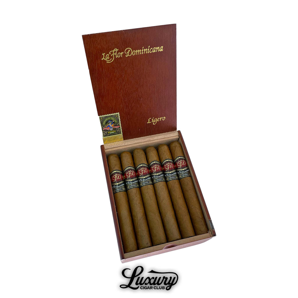 La Flor Dominicana Ligero Natural I-300 cigars neatly arranged in an open wooden box with bold red and gold branding, showcasing their premium craftsmanship, featured by Luxury Cigar Club.