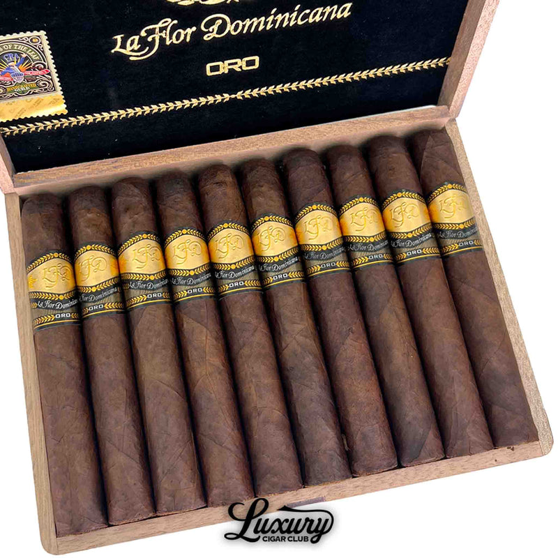 Luxury Cigar Club close up of La Flor Dominicana Oro Maduro No 6 cigars displayed in an open box highlighting the rich maduro wrapper and detailed gold Oro cigar bands.
