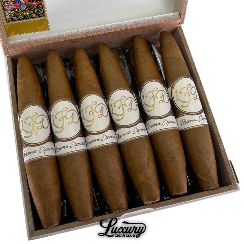 Close-up of La Flor Dominicana Reserva Especial El Jocko cigars showing smooth Connecticut wrappers and elegant gold-banded design, from Luxury Cigar Club.
