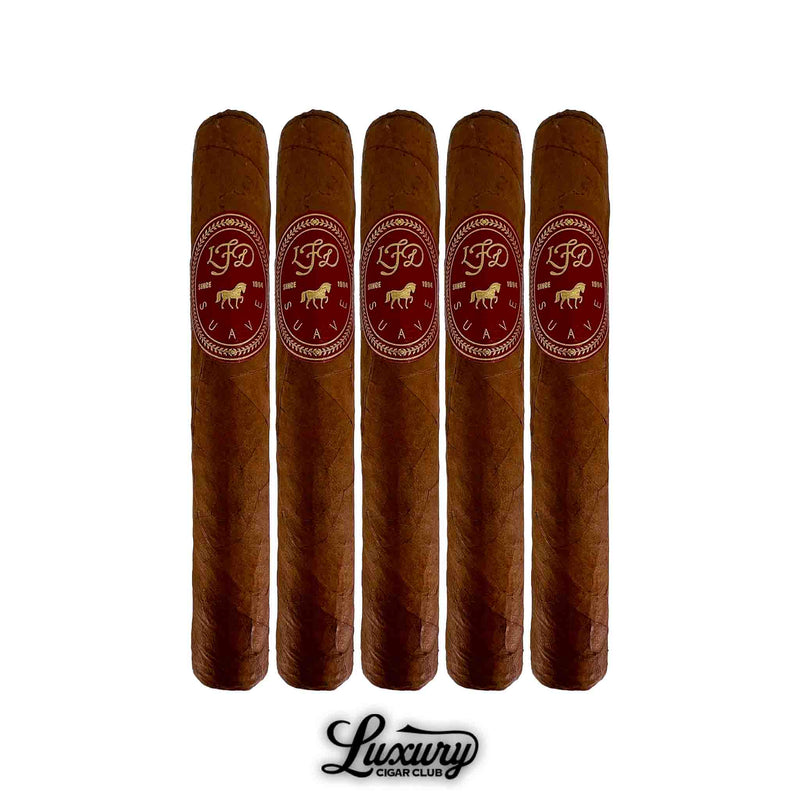 Five La Flor Dominicana Suave Natural Maximo cigars displayed upright, showcasing silky Connecticut wrappers with signature red and gold LFD bands. A refined, mild-bodied cigar presentation. Luxury Cigar Club.
