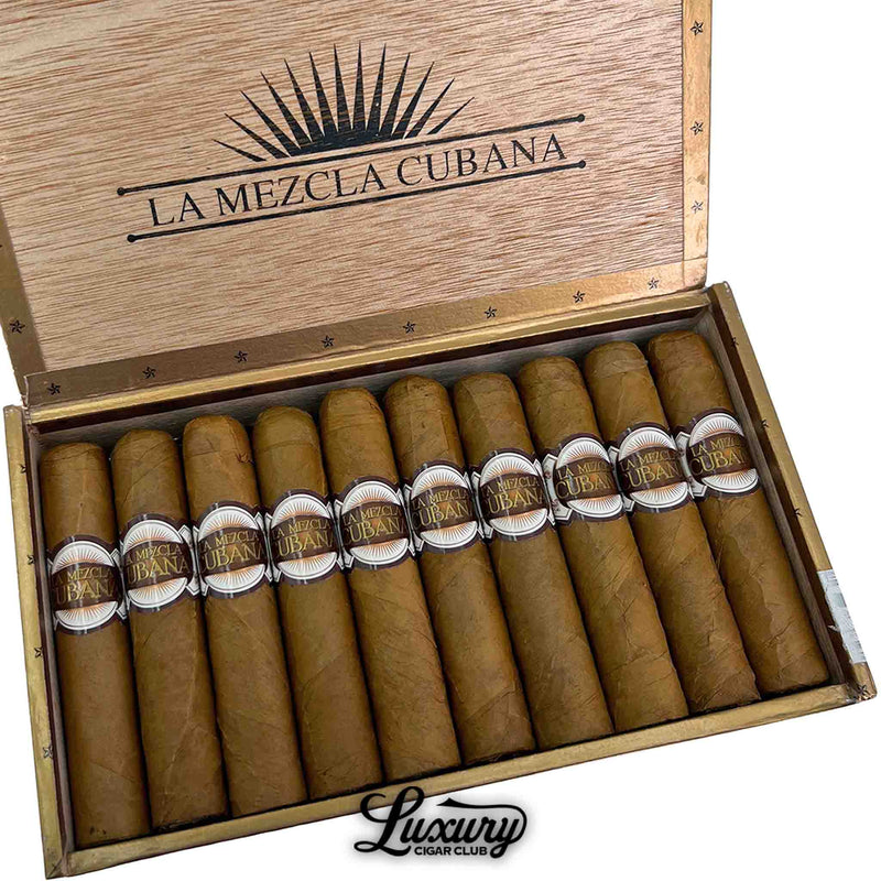 Close-up of La Mezcla Cubana Rothschild cigars inside an open box, highlighting the smooth golden-brown wrappers and detailed cigar bands. Luxury Cigar Club logo below.