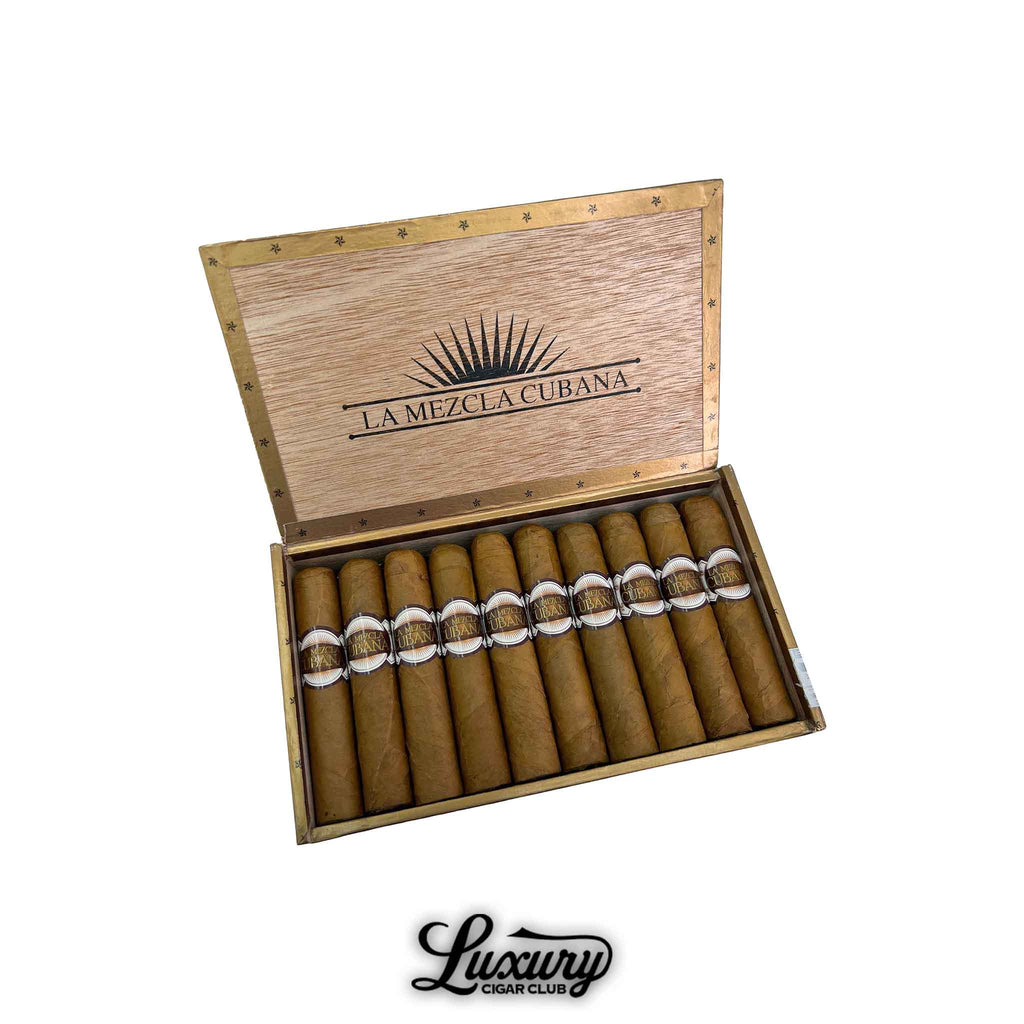 Open wooden box of La Mezcla Cubana Rothschild cigars displaying twelve Connecticut-wrapped cigars with elegant brown and gold bands. Luxury Cigar Club logo shown beneath.