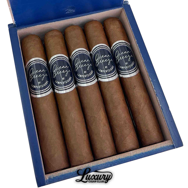 Close-up of Lampert Ocean Breeze Robusto Grande cigars with dark blue and silver bands, featured by Luxury Cigar Club.