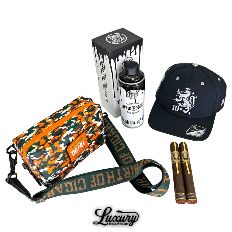 Luxury Cigar Club product image featuring the Liga Privada Black Friday 2025 Freebie Sampler No 3 freebies including a Drew Estate camo DE4L bag, a Drew Estate spray can humidor, a black 10th anniversary hat, and two Drew Estate cigars arranged neatly.