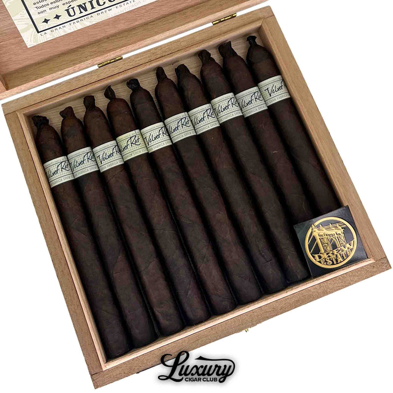 Close up of Liga Privada Unico Series Velvet Rat cigars neatly arranged inside an open box, showcasing dark wrappers and white labels, Luxury Cigar Club.