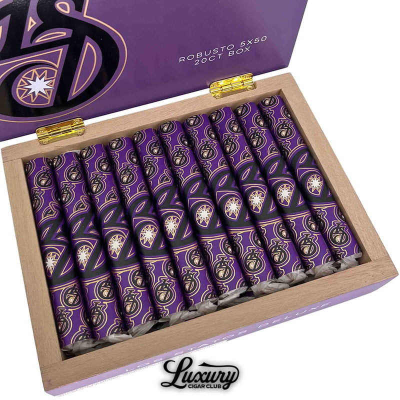 Close-up of Los Statos Deluxe Connecticut Robusto cigars highlighting the striking purple and gold design with the signature LS logo, featured by Luxury Cigar Club.
