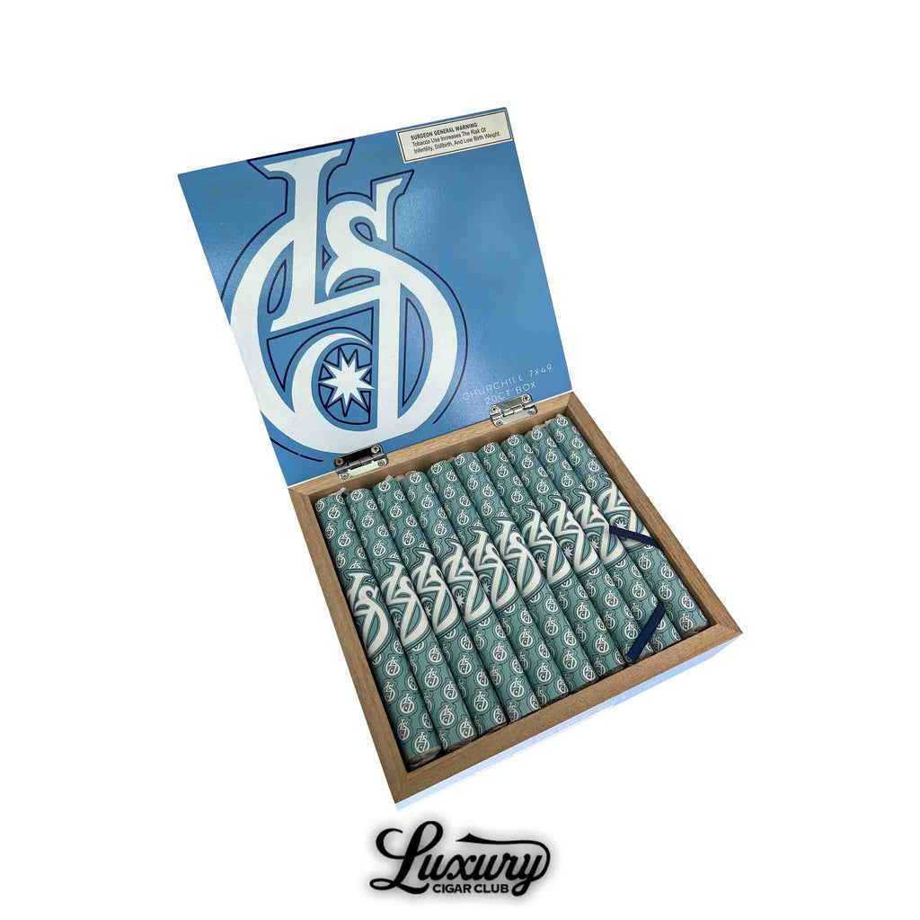 Open box of Los Statos Deluxe Maduro Churchill cigars with teal and white wrapped sticks, Luxury Cigar Club branding below.