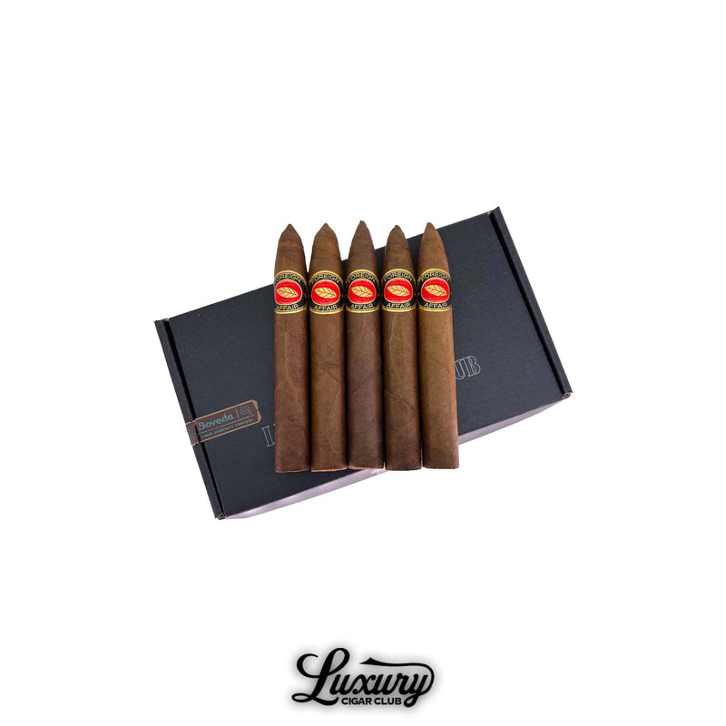 Luciano Foreign Affair premium cigars with red and gold bands displayed on a Luxury Cigar Club black box, hand-rolled torpedo cigars available to buy online.